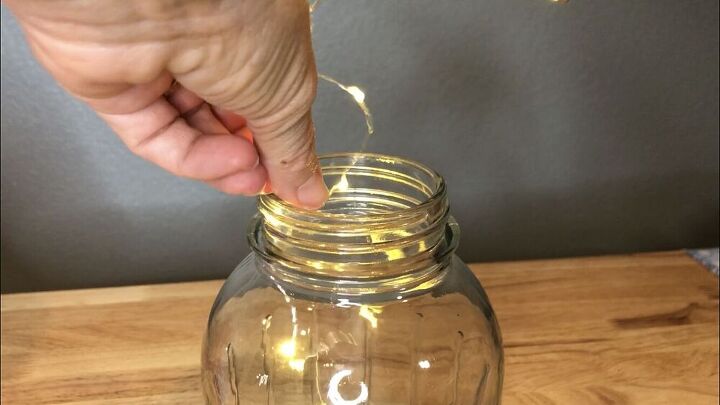 The base of this lamp was a mason jar.  I emptied out the old potpourri, and washed it out.  I added a strand of LED lights into the jar.  This would create a lightning bug or firefly look. 