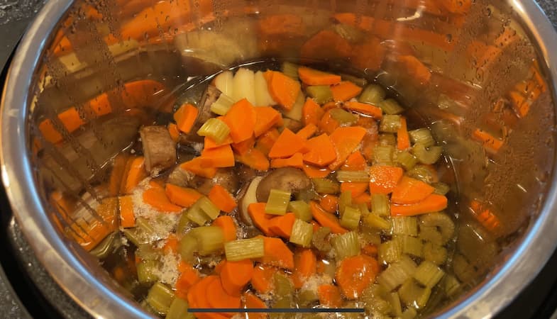 I started by placing some carrots, celery and potatoes in my Instant Pot with the 2 cups water.  I did measure but if I had to guess I used 1 cup of each.