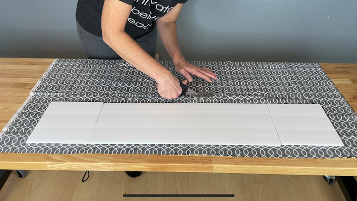 I laid my fabric out and placed the foam core board on top so that I could cut the fabric.  I added 2 inches to every side so that I'd have plenty of fabric to glue onto the board.