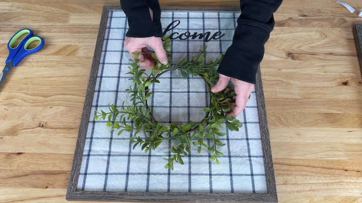 8.  Place a wreath on the hook on the picture frame.  