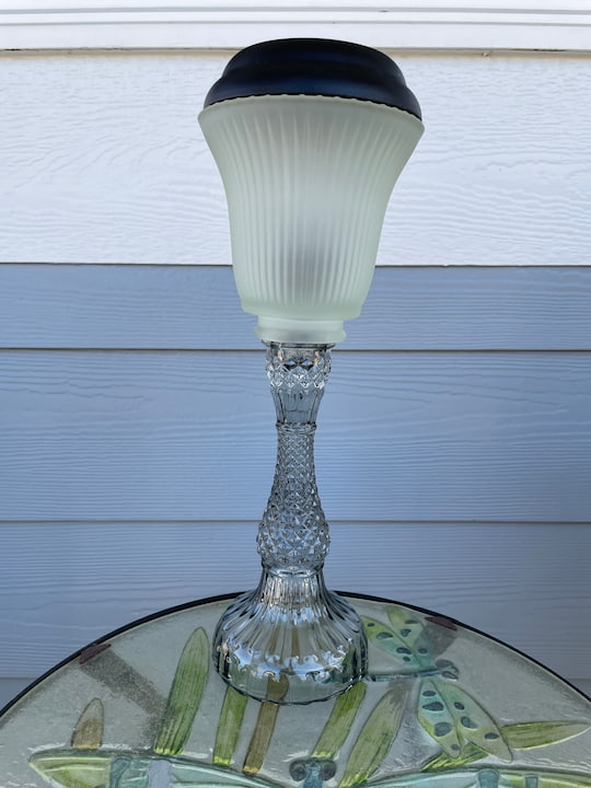 For this one I placed it outside on my porch table.  I pulled apart a solar light and placed the light into the light fixture end of the lamp shade.