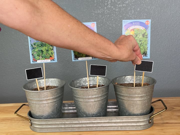I added chalkboard garden markers to each planter so that when the seeds are planted they can write the name of what they planted in each flower pot.  