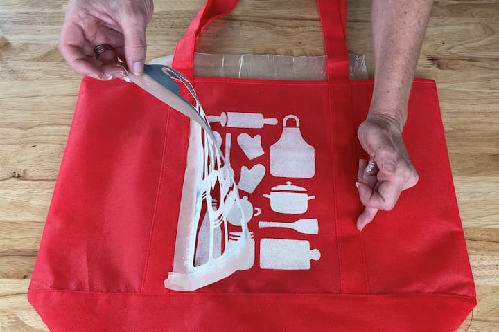 Once I finished covering the stencil with paint, I immediately carefully peeled the stencil off the bag.  You want to remove the stencil right away so the paint doesn't stick to it.  If paint sticks to the stencil and you lift it, sometimes the paint will come back off the surface with the stencil.