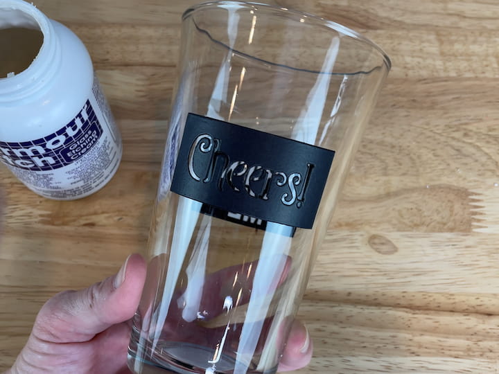 I purchased a pint glass and I washed and dried it.  I wiped the entire glass with rubbing alcohol to make sure it was clean of all finger prints, oil, and dirt.  I placed an adhesive stencil onto the glass.