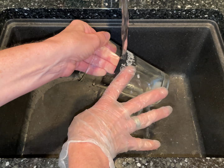 Rinse the etching cream off the glass.  I use rubber gloves to protect my hands.