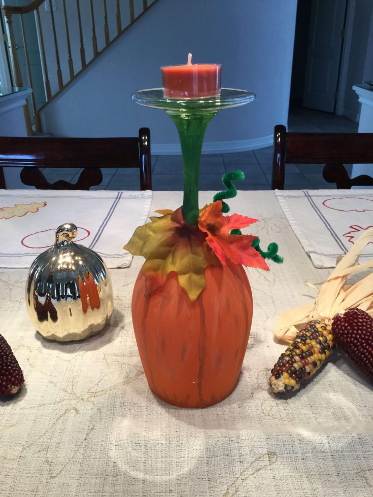 Have you seen the wine glasses turned into pumpkin candle holders? I have and I’ve been wanting to give them a try. I finally did and just in time for a fall centerpiece for our Thanksgiving table! This is an easy craft and inexpensive to make. You can find the full tutorial at Wine Glasses to Pumpkin Candles