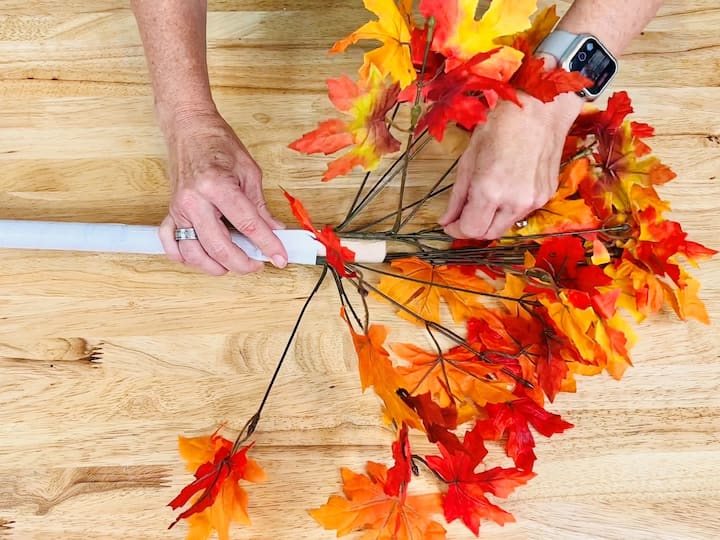 Bend the branches outward to give the plunger a tree-like shape. Using black paint, tap the duct tape to mimic the appearance of birch or aspen trees.