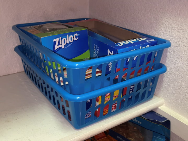 I have filled up 2 of these containers with storage baggies, plastic wrap, tinfoil, wax paper, etc. and then I can stack them vertically in my pantry.  This saves space, helps them look organized, and they stay in place.