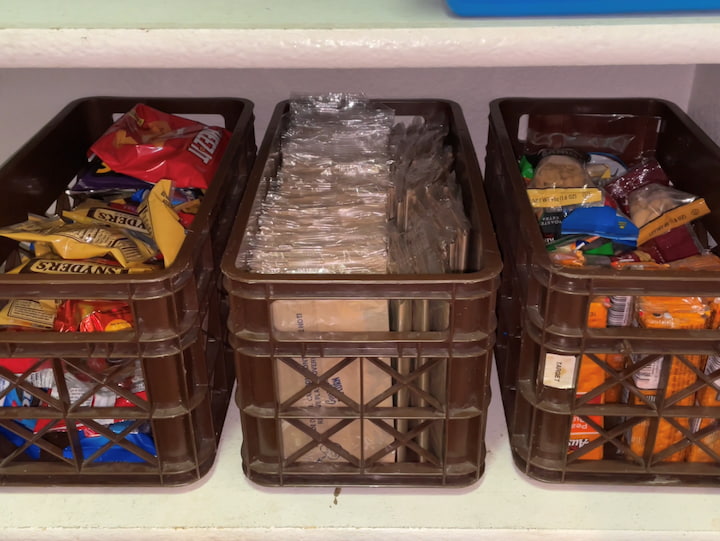 I use 3 long and deep containers that will go on my shelves side by side.  One container is the salty and sweet snacks, the next is popcorn bags, and one container is more protein-based snacks.  This way I don't have lots of bags and boxes in my pantry, and it looks nicer.  My kids have an easier time getting what they want on their way to activities and helping in packing lunches for school.