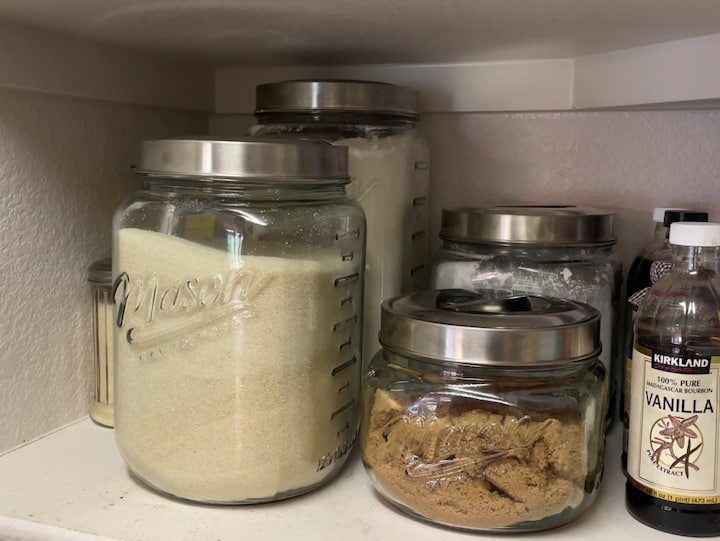 To keep my flour, sugar, brown sugar, and powder sugar long term I tore them in air-tight containers.  I'm also able to utilize the depth of the shelf to put 2 in a row.  This helps utilize the space in my pantry, and they look nice.