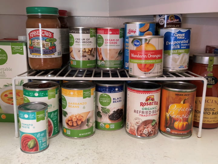 I use wire shelves in my pantry.  A lot of times we have tall space that is unused.  Cans are a great example of this. I put a wire shelf in my pantry to give me more space.  I organize my cans by likeness, meaning there is a row of vegetables, a row of fruit, etc. I also only keep cans of items I use on a regular basis.  
