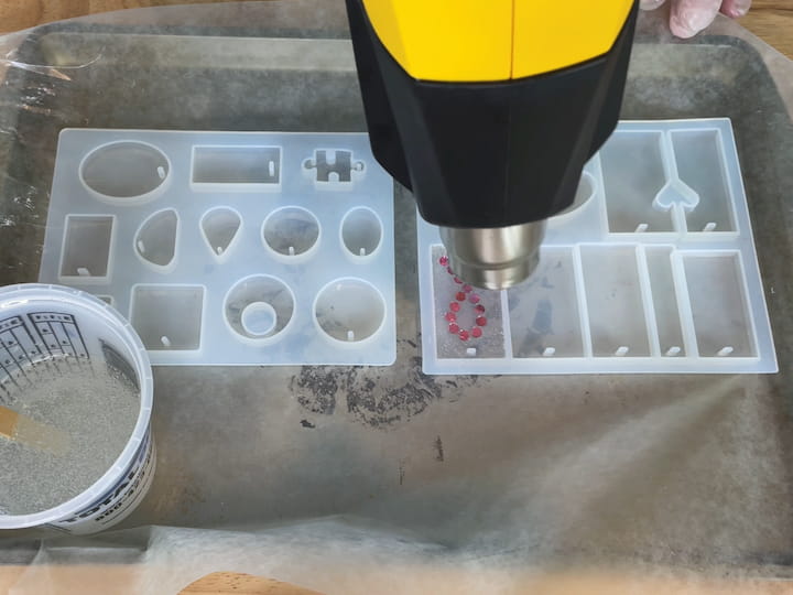 use a heat gun to pop the bubbles