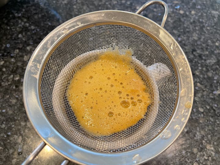 If you want to filter it more, place a strainer over your glass, and pour the juice through it.  