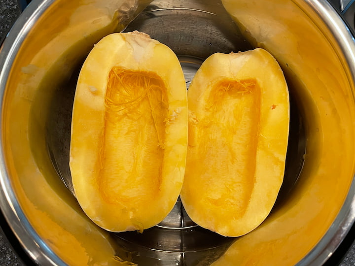 Place your spaghetti squash in an Instant Pot with 1/2 cup water.