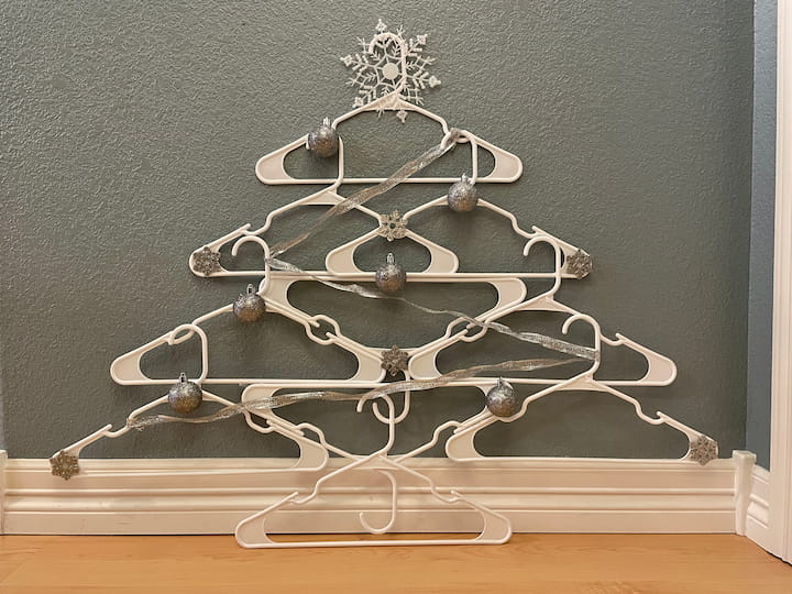 Did you know you can craft with hangers?  I created this easy and space-saving Christmas tree out of white plastic hangers and accessories.