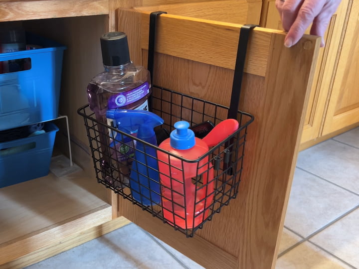 To utilize the depth of our cabinets and gain some extra space I purchased these over the cabinet door baskets.  This particular basket came in a set of 2.  I placed it near the center of the bathroom so both kids could reach the common supplies they grab every day.