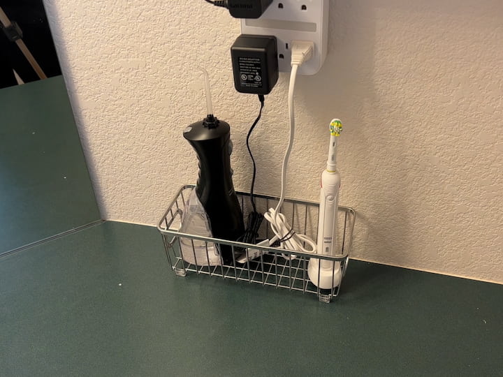 Unfortunately, his toothbrush and Waterpik wouldn't fit inside the cabinet, so I purchased a small basket to place these items in.  The basket will hold the cords and they can pick up the basket easily for cleaning counters.
