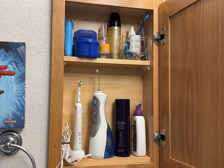This bathroom came with 1 built-in medicine cabinet.  I set up this side so that my daughter's toothbrush, Waterpik, and other daily used supplies could fit in here.  This would also keep the counter open.