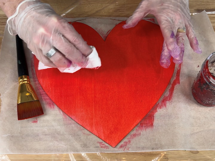 After I painted the entire piece, I wiped it gently with a paper towel to remove the excess.  Once this side was dry, I repeated the process on the other side.  It dries really fast so it didn't take long to knock these hearts out.