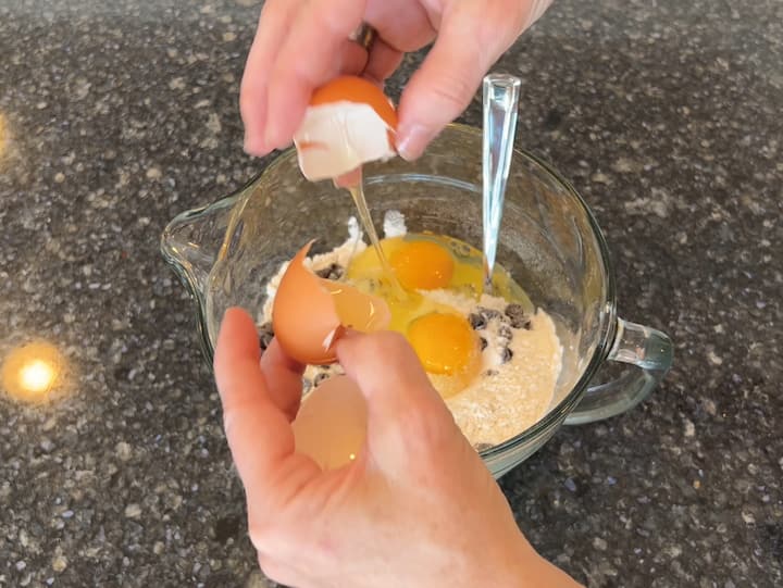 Add 2 eggs to the bowl.