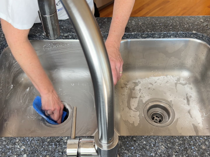 I use a non-scratch scour pad and scrub my sink.  The baking soda does not kill germs but it does remove a lot of the gunk sticking around in your sink.