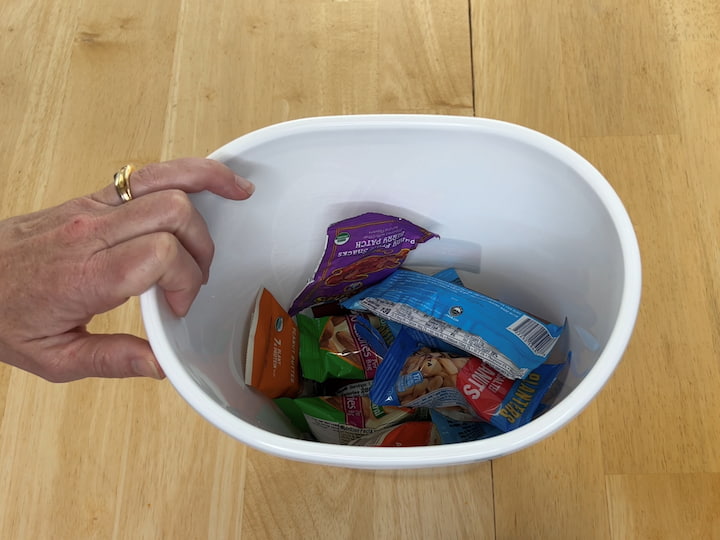 You can also use this organization hack for snacks.  Break the snacks down by type (protein, crackers, treats), or just place them in a trash bin.  You can place a bin like this by your door for quick grab-and-go snacks, or you can place them in your kitchen for easy-to-reach snacks.