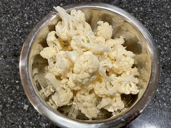 Wash your cauliflower head and break it apart into wing size sections.
