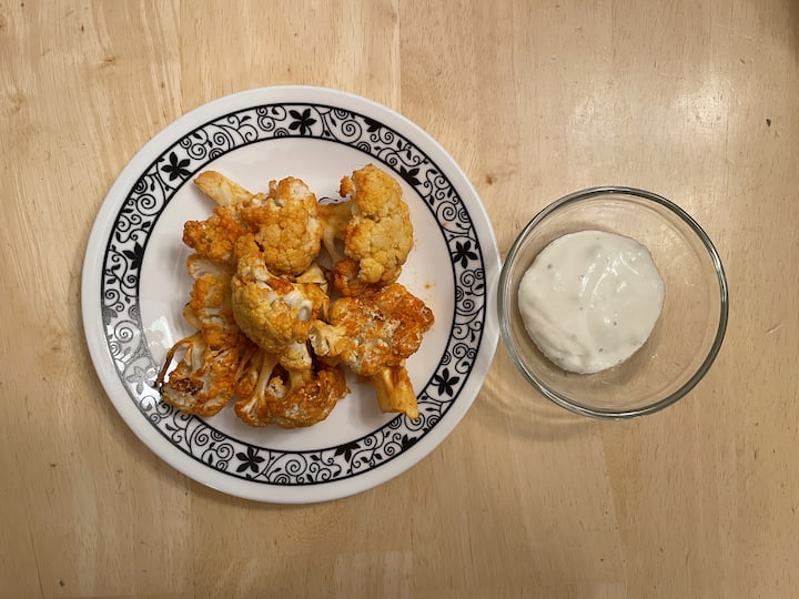 We like to eat it with vegan blue cheese dressing.  I also love to serve a side of celery sticks with it.  This will help cool your mouth down and it refreshing while eating the spicy cauliflower wings.