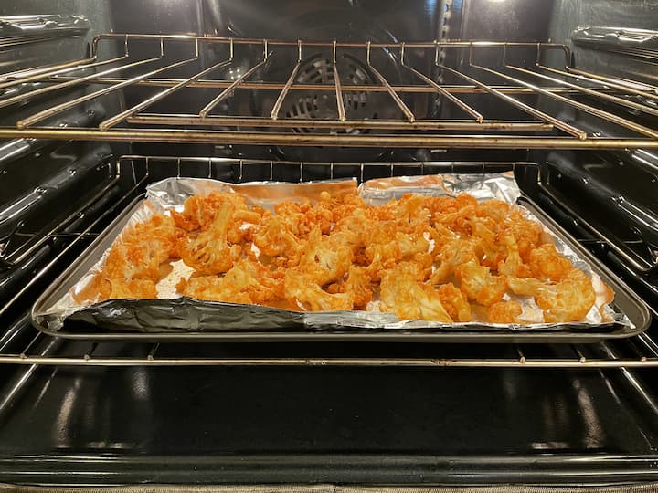 Place on a foil-lined baking sheet.  Preheat the oven to 350 degrees, and bake the cauliflower for approximately 10 to 20 minutes.
