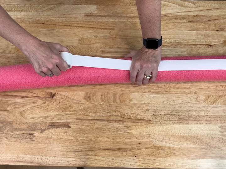 I added athletic tape to the pool noodles to create stripes like on the flag.