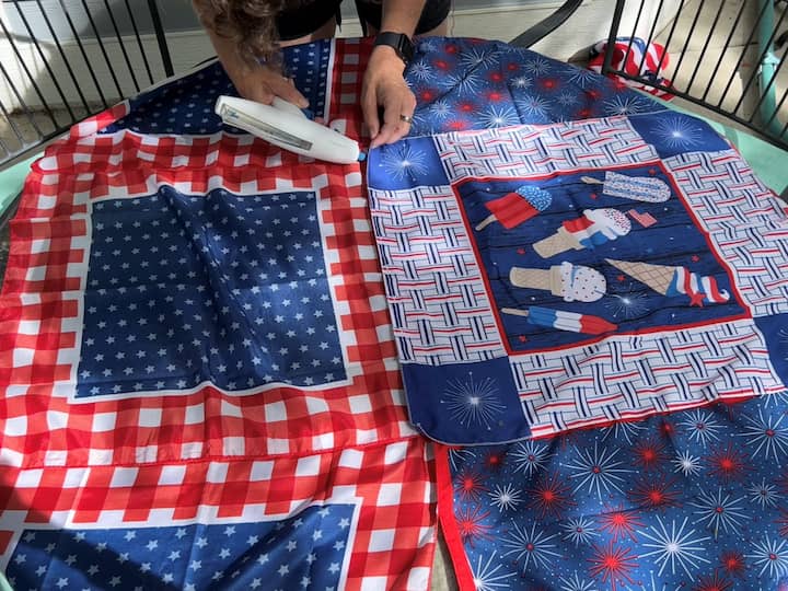 I hot glued each of the strips together to form a table cloth big enough to cover our patio table.  You can easily adjust this to fit any size table you like.