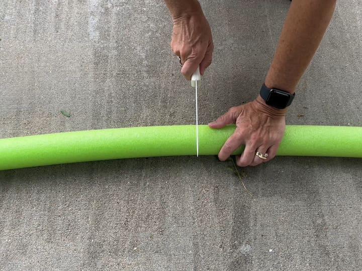 I cut a pool noodle in half using a serrated knife.