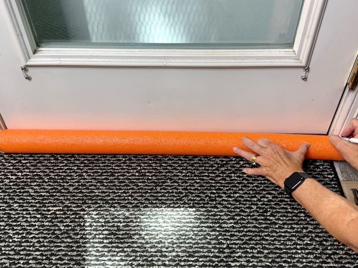 Do you have cold or hot air leaking into your house?  Make a simple door draft stopper.  I started by measuring a pool noodle against a door.