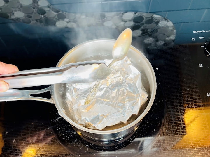I removed the silver spoon out and let it cool.  You can find the full tutorial of all of my silver cleaning hacks at 6 Astonishing and Winning Cleaning Silver Hacks