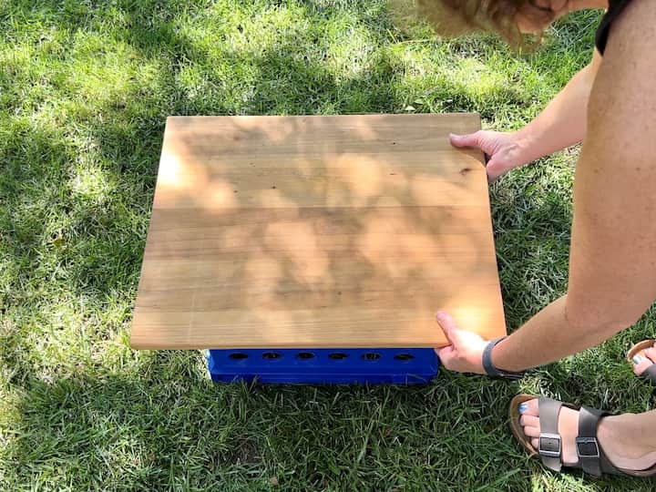 I had a large cutting board that I placed on top of the crate/s.  You could easily have a board cut at your local hardware store to place on top.