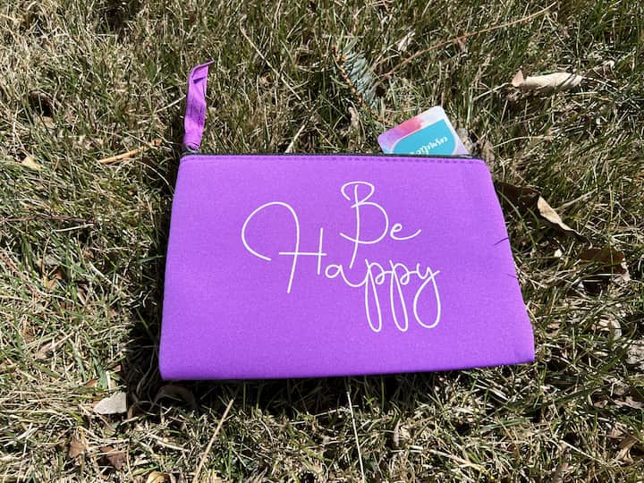 For this next project, I'll be using a bag that can be used in your purse or travel bag. It is fabric and says be happy on one side but the back side is plain. I found a transfer sheet that says be happy.