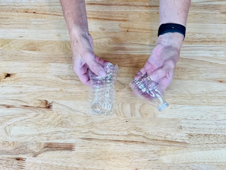 I cut an empty water bottle in half using utility scissors.
