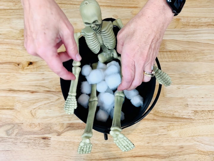1. Place skeleton and cotton balls in a cauldron.