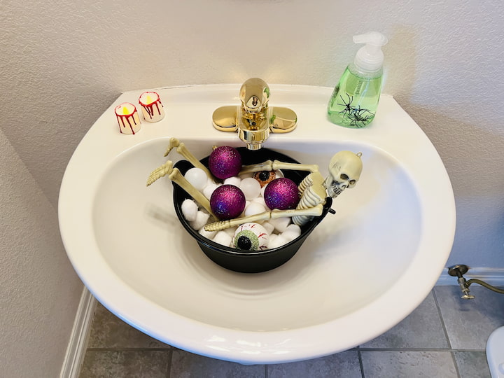 I will take the bulbs with the eyeballs and place them in here as well, and what I've created is a bubble bath for the skeleton.