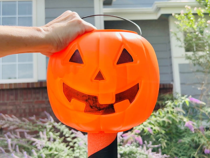 Next, I take a pumpkin pail and place it on top. 