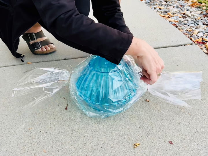 I cut a piece of cellophane wrap so it would wrap all the way around the two bowls. Next I cut some twine and pinched the ends so it looked like a wrapped piece of candy. 