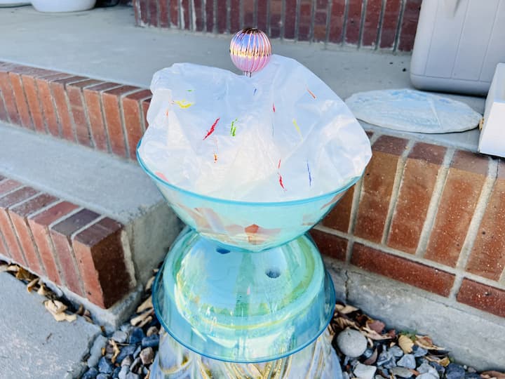 Now it's time to put everything in place. I placed the lollipops alongside my walkway and the sundaes on either side of my front door on upside down flower pots. I took my paint pens and added a few dashes as sprinkles on my ice cream. 