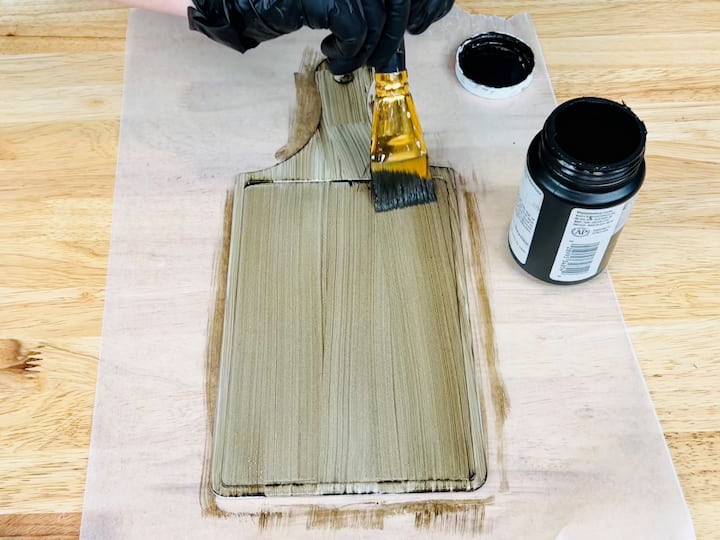 Next, you're going to use the folk art home decor wood tint in the color Walnut. You want this to look grainy to resemble actual wood. Once you get the desired look you're going to let it dry completely. 