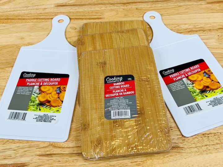 For the next project, you're going to need two white cutting boards and three bamboo cutting boards. I started with E6000 glue and I put it