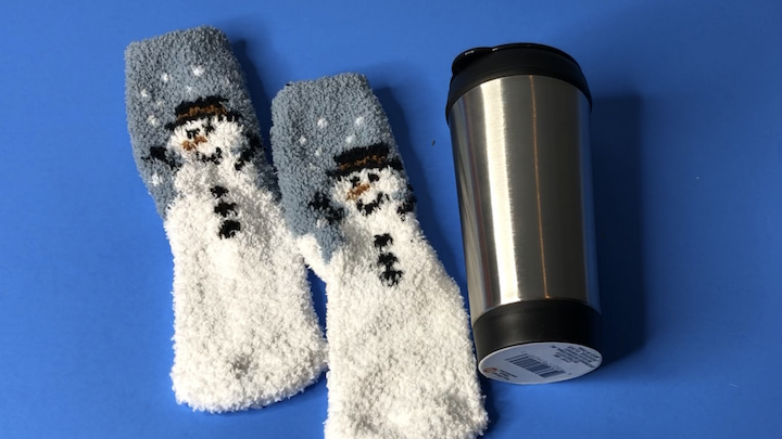 For this last example, I'm not going to cut the sock. Instead, I will slide the entire sock on the travel mug. I rolled the top to the inside so there would be room to drink.