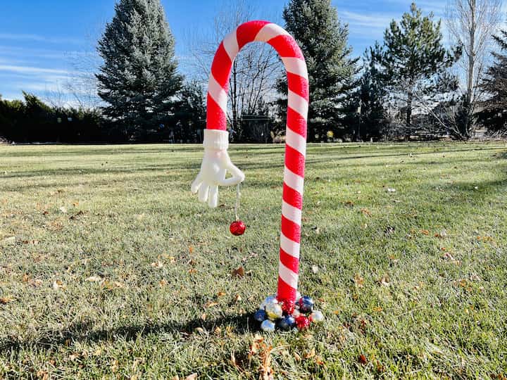 Are you looking for a grinch candy cane?  I ran to Dollar Tree and made this easy and awesome DIY for just a couple of dollars.