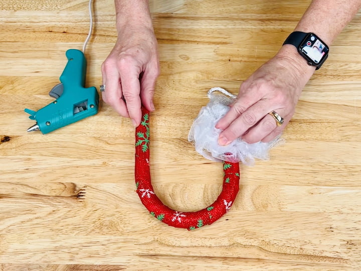 3.  Hot Glue a white loofah onto the top of the candy cane