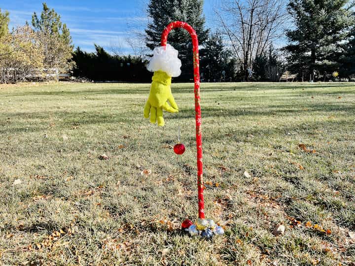 Are you looking for a grinch candy cane?  I ran to Dollar Tree and made this easy and awesome DIY for just a couple of dollars.