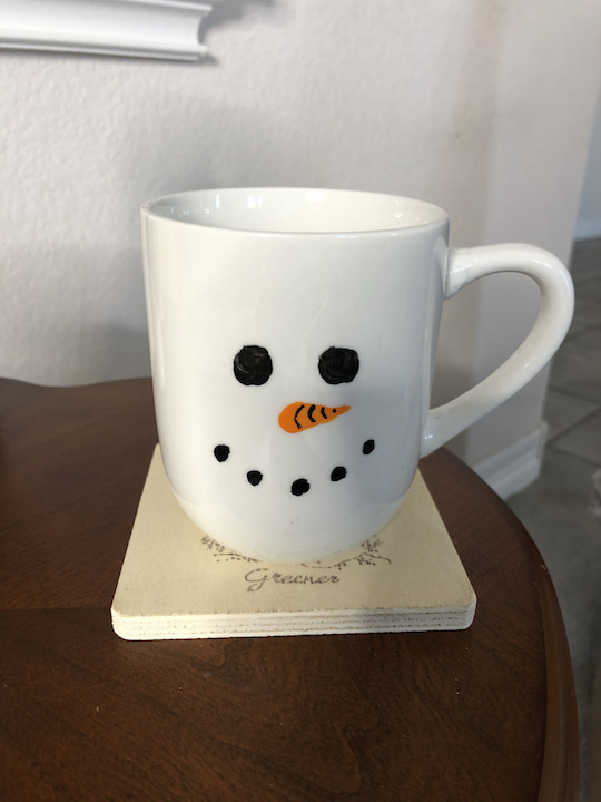I used some paint that was meant for glass, painted on a snowman face, and followed the instructions for cure time. You can see my full snowman mug tutorial and I will show how I turned it into a fun gift as well.