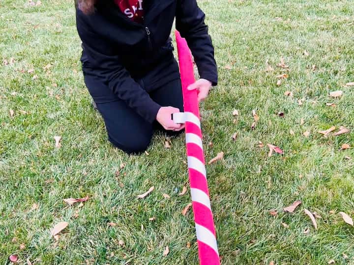 I will be using red pool noodles as my lollipop stick. I will use athletic tape and twist it around the pool noodle to make candy stripes.